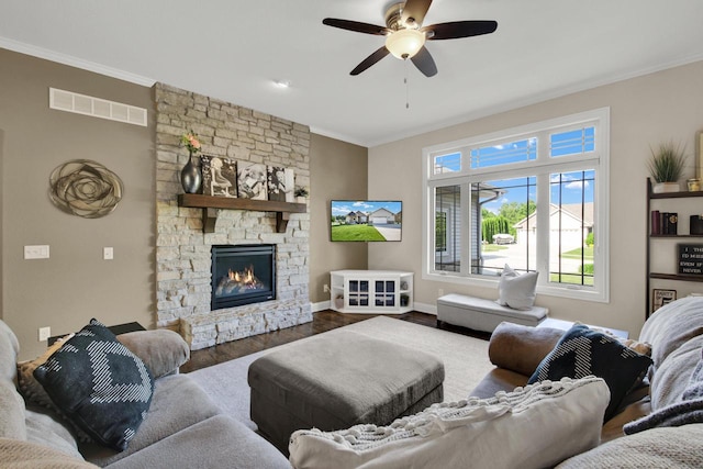 1395 American Eagle Dr, Slinger, WI 53086 - living area with ornamental molding, dark wood-type flooring, ceiling fan, and a fireplace