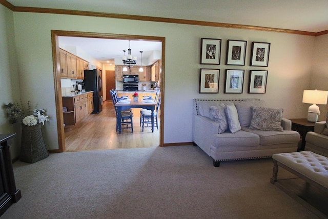 1000 Ridge Rd, Waukesha, WI 53186 - living room with a chandelier, crown molding, light colored carpet, and light wood-style floors