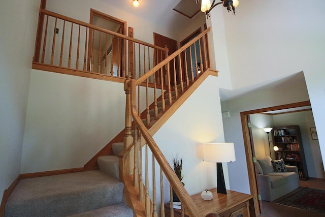 1000 Ridge Rd, Waukesha, WI 53186 - staircase featuring carpet and a towering ceiling