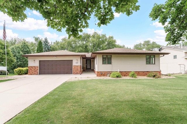 915 Nelson Ave, Milton, WI 53563 - view of front of property with brick siding, a garage, a front lawn, and driveway