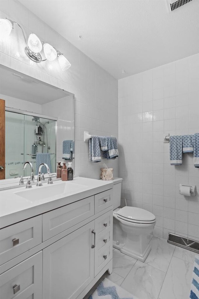 915 Nelson Ave, Milton, WI 53563 - full bathroom with tile walls, vanity, a shower stall, and marble finish flooring