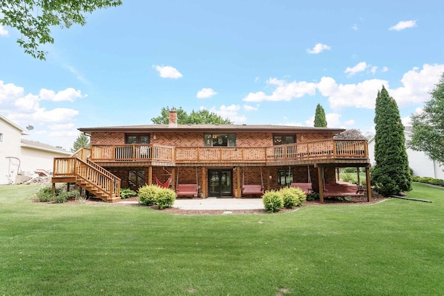 915 Nelson Ave, Milton, WI 53563 - back of house featuring stairs, a deck, brick siding, and a lawn