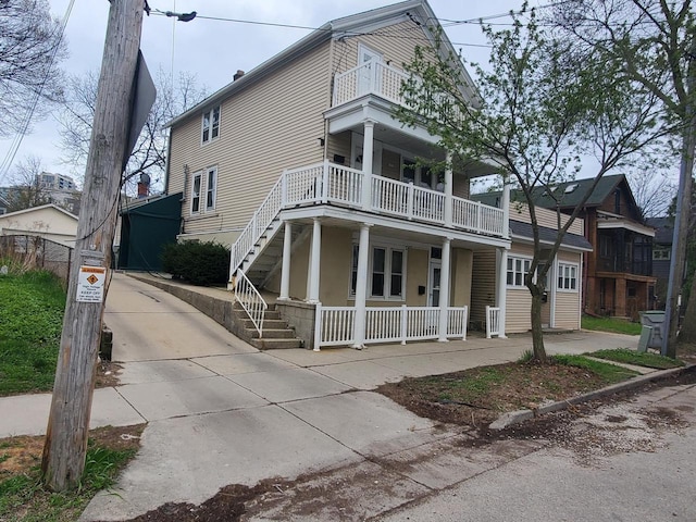 1816 N Arlington Pl Unit 1818, 1818A, Milwaukee, WI 53202 - view of front of house featuring a balcony, covered porch, and stairway