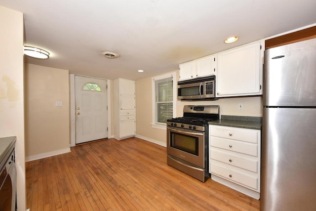 1816 N Arlington Pl Unit 1818, 1818A, Milwaukee, WI 53202 - kitchen with appliances with stainless steel finishes, dark countertops, light wood finished floors, white cabinets, and recessed lighting