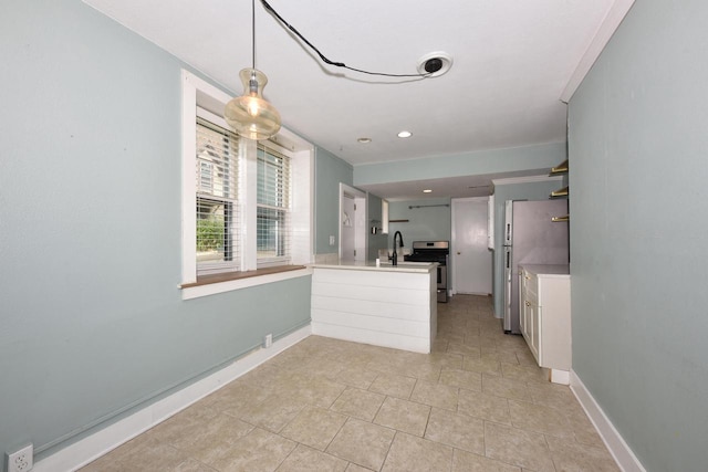 1816 N Arlington Pl Unit 1818, 1818A, Milwaukee, WI 53202 - kitchen with a peninsula, stainless steel range oven, freestanding refrigerator, light countertops, and decorative light fixtures