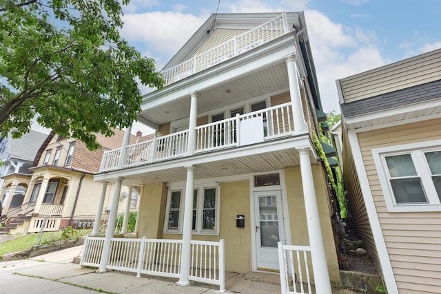 1816 N Arlington Pl Unit 1818, 1818A, Milwaukee, WI 53202 - view of front of home with a balcony, a porch, and stucco siding