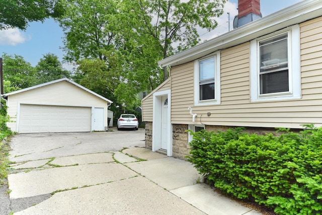 1816 N Arlington Pl Unit 1818, 1818A, Milwaukee, WI 53202 - view of home's exterior with a detached garage, an outbuilding, and a chimney