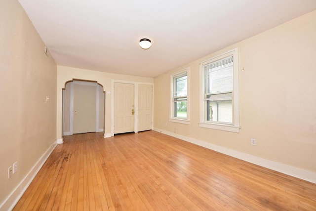 1816 N Arlington Pl Unit 1818, 1818A, Milwaukee, WI 53202 - spare room featuring light wood finished floors and arched walkways