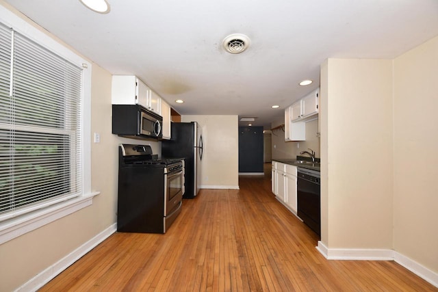 1816 N Arlington Pl Unit 1818, 1818A, Milwaukee, WI 53202 - kitchen featuring stainless steel appliances, light wood finished floors, white cabinetry, dark countertops, and recessed lighting