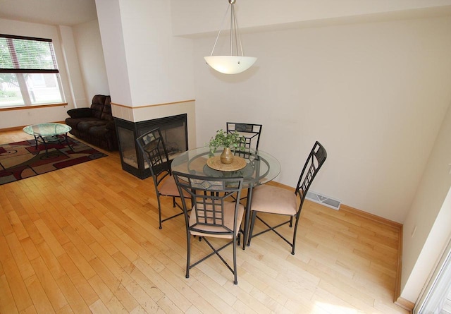 65 S Gardens Way, Fitchburg, WI 53711 - dining space featuring wood finished floors and a multi sided fireplace