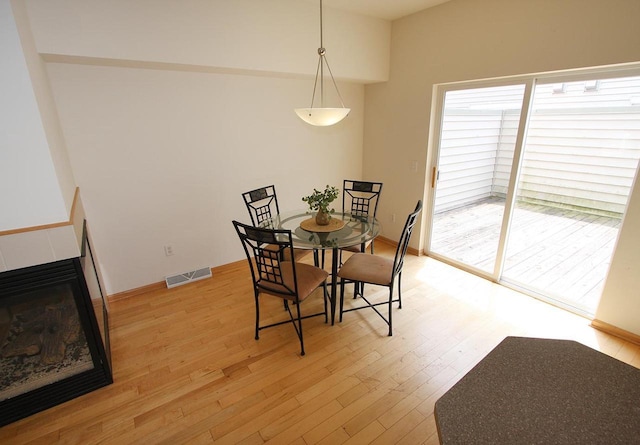 65 S Gardens Way, Fitchburg, WI 53711 - dining room featuring light wood-style floors and a multi sided fireplace