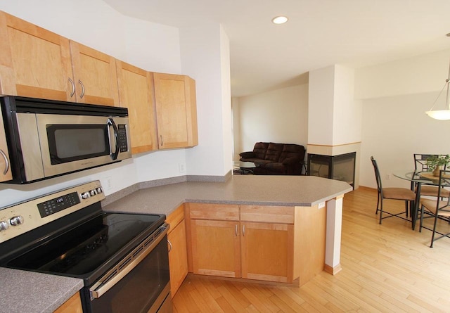 65 S Gardens Way, Fitchburg, WI 53711 - kitchen featuring stainless steel appliances, light wood-style flooring, a peninsula, light brown cabinetry, and recessed lighting