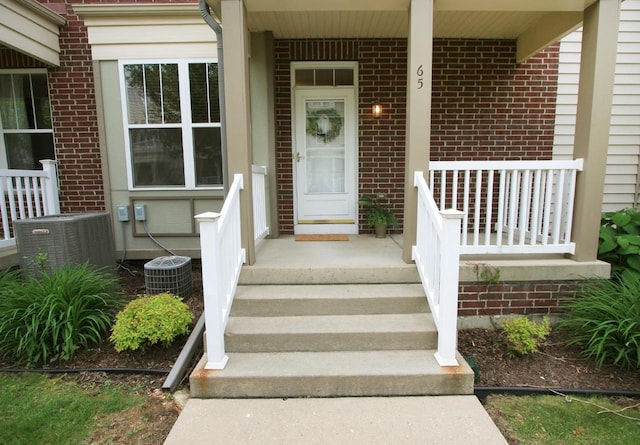 65 S Gardens Way, Fitchburg, WI 53711 - doorway to property featuring brick siding and a porch
