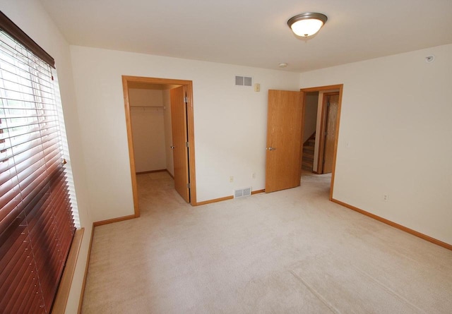 65 S Gardens Way, Fitchburg, WI 53711 - unfurnished bedroom featuring light colored carpet, a walk in closet, and a closet