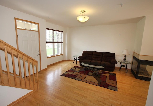 65 S Gardens Way, Fitchburg, WI 53711 - living room with light wood finished floors, stairs, and a multi sided fireplace