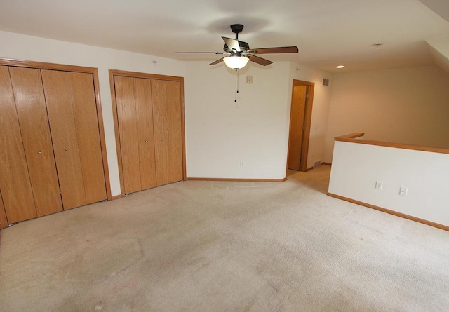 65 S Gardens Way, Fitchburg, WI 53711 - unfurnished bedroom featuring multiple closets, light colored carpet, ceiling fan, and recessed lighting