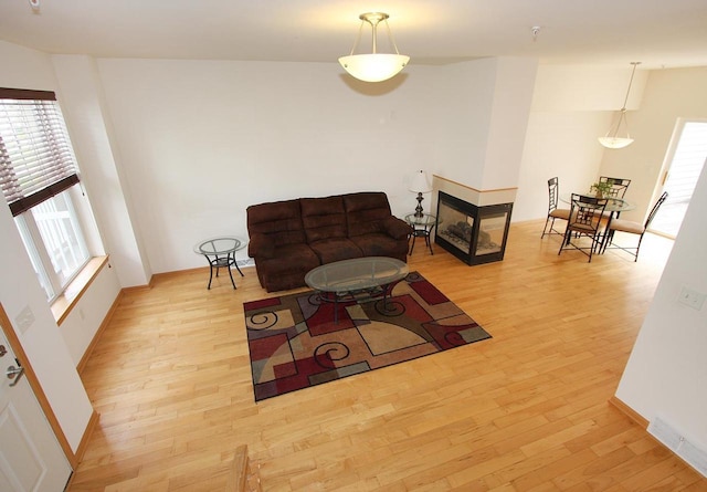 65 S Gardens Way, Fitchburg, WI 53711 - living area featuring wood finished floors and a multi sided fireplace