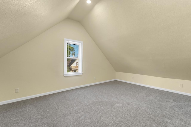 3124 N 29th St, Milwaukee, WI 53216 - additional living space featuring lofted ceiling, carpet floors, and a textured ceiling