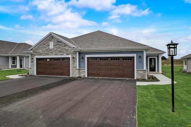 516 Hickory Hollow Rd Unit 0402, Waterford, WI 53185 - view of front of house featuring stone siding, driveway, a front yard, an attached garage, and a shingled roof