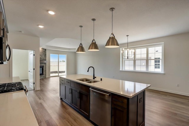 516 Hickory Hollow Rd Unit 0402, Waterford, WI 53185 - kitchen with stainless steel appliances, wood finished floors, light countertops, dark brown cabinetry, and recessed lighting