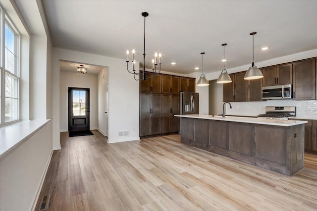 516 Hickory Hollow Rd Unit 0402, Waterford, WI 53185 - kitchen featuring stainless steel appliances, light countertops, light wood-style flooring, and recessed lighting