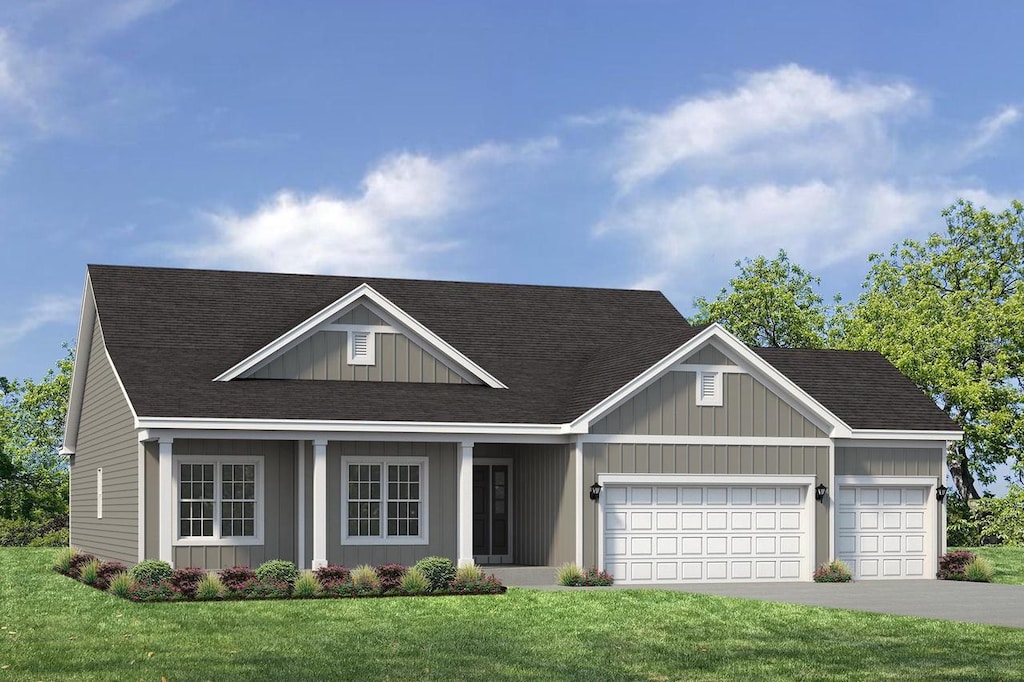 527 N Boulder Ridge Dr, Lake Geneva, WI 53147 - view of front of house with a garage, a front lawn, driveway, a shingled roof, and board and batten siding