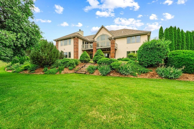 N66W38493 N Woodlake Cir, Oconomowoc, WI 53066 - rear view of property featuring a yard, a chimney, and stairs