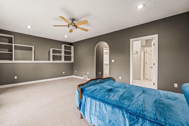 N66W38493 N Woodlake Cir, Oconomowoc, WI 53066 - carpeted bedroom featuring arched walkways, recessed lighting, ensuite bathroom, and ceiling fan