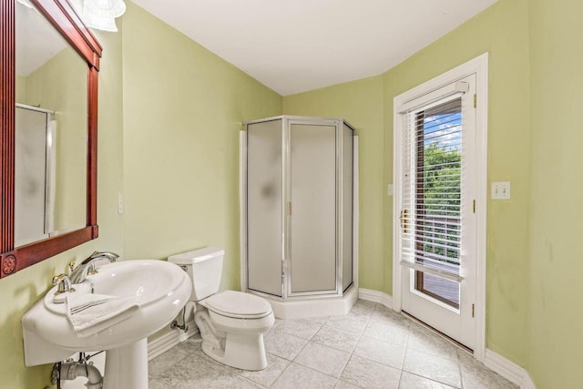 N66W38493 N Woodlake Cir, Oconomowoc, WI 53066 - bathroom with a stall shower and tile patterned flooring