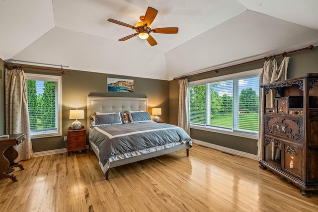 N66W38493 N Woodlake Cir, Oconomowoc, WI 53066 - bedroom featuring wood finished floors, lofted ceiling, multiple windows, and ceiling fan