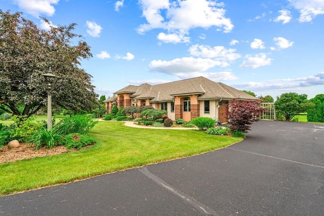 N66W38493 N Woodlake Cir, Oconomowoc, WI 53066 - view of front of house with a front lawn and stucco siding