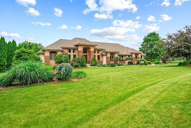 N66W38493 N Woodlake Cir, Oconomowoc, WI 53066 - view of front of house featuring a front lawn and stucco siding