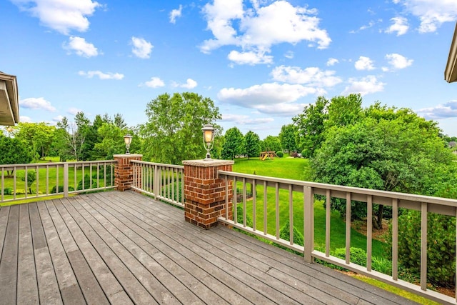 N66W38493 N Woodlake Cir, Oconomowoc, WI 53066 - wooden deck featuring a lawn and view of wooded area