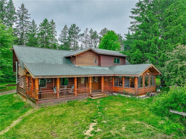 14097 W State Road 77, Hayward, WI 54843 - cabin featuring covered porch, a shingled roof, and a front lawn