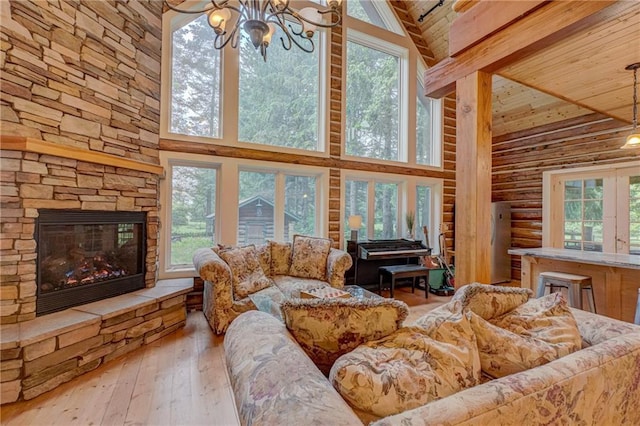 14097 W State Road 77, Hayward, WI 54843 - living room with high vaulted ceiling, a chandelier, wood-type flooring, a wooden ceiling with exposed beams, and rustic walls