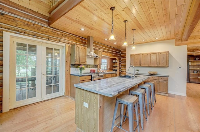 14097 W State Road 77, Hayward, WI 54843 - kitchen featuring wood ceiling, wall chimney range hood, rustic walls, stainless steel gas stove, and light wood-style flooring