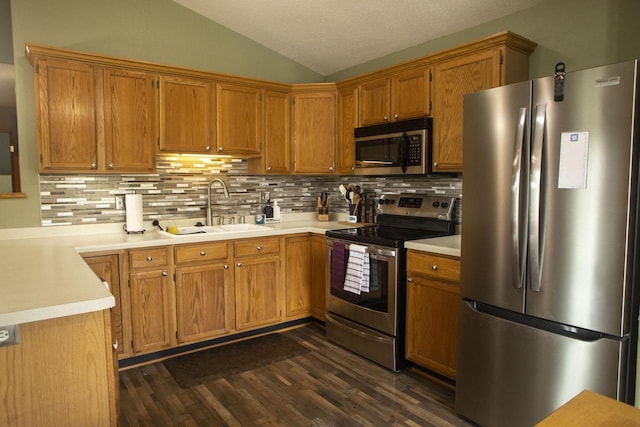 156 Pheasant Run Unit D-4, Johnson Creek, WI 53038 - kitchen featuring appliances with stainless steel finishes, vaulted ceiling, light countertops, tasteful backsplash, and dark wood-style flooring