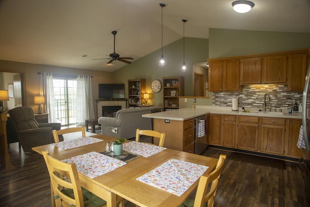 156 Pheasant Run Unit D-4, Johnson Creek, WI 53038 - dining area with dark wood-type flooring, ceiling fan, a fireplace, and high vaulted ceiling