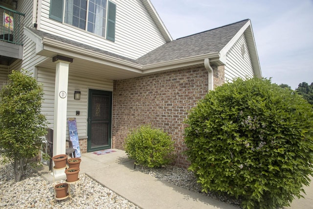 156 Pheasant Run Unit D-4, Johnson Creek, WI 53038 - doorway to property with brick siding and a shingled roof