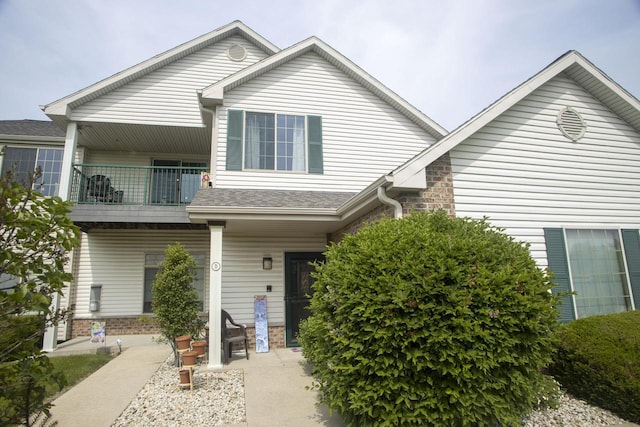 156 Pheasant Run Unit D-4, Johnson Creek, WI 53038 - view of front of property with a balcony, covered porch, and brick siding
