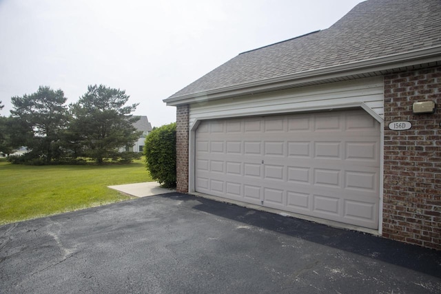 156 Pheasant Run Unit D-4, Johnson Creek, WI 53038 - garage featuring asphalt driveway
