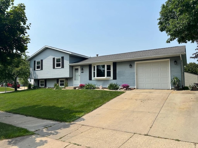 2332 Hughes Ln, Waukesha, WI 53188 - split level home with an attached garage, a front lawn, and driveway