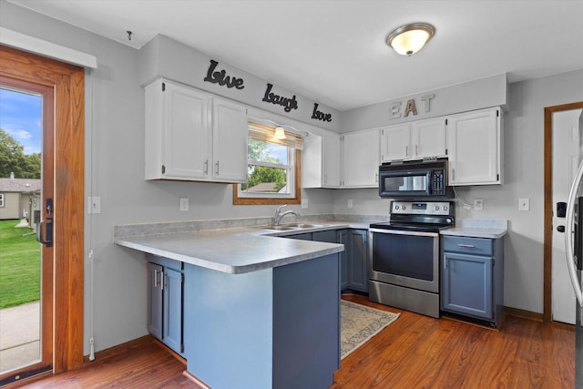 2332 Hughes Ln, Waukesha, WI 53188 - kitchen with black microwave, stainless steel range with electric stovetop, white cabinets, and a peninsula