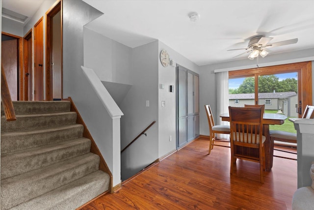 2332 Hughes Ln, Waukesha, WI 53188 - dining space with wood finished floors, a ceiling fan, and stairs