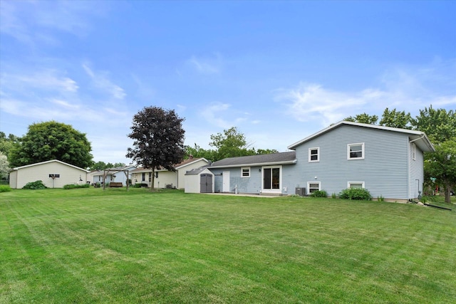 2332 Hughes Ln, Waukesha, WI 53188 - back of house featuring a storage shed and a lawn