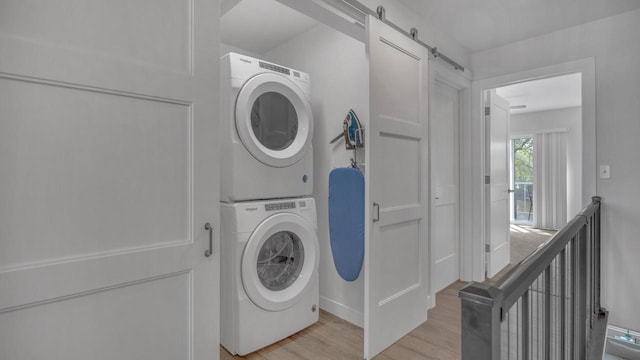 814 N 15th St Unit B, Sheboygan, WI 53081 - laundry area with stacked washer and clothes dryer, light wood-style floors, and a barn door