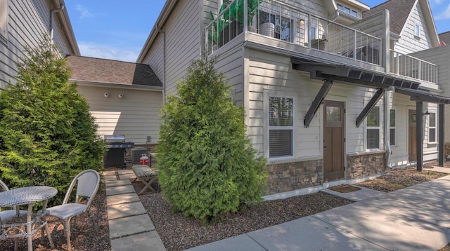 814 N 15th St Unit B, Sheboygan, WI 53081 - view of side of home featuring a balcony and stone siding