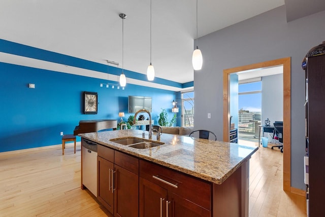 106 W Seeboth St Unit 702, Milwaukee, WI 53204 - kitchen with stainless steel dishwasher, light wood finished floors, pendant lighting, and open floor plan