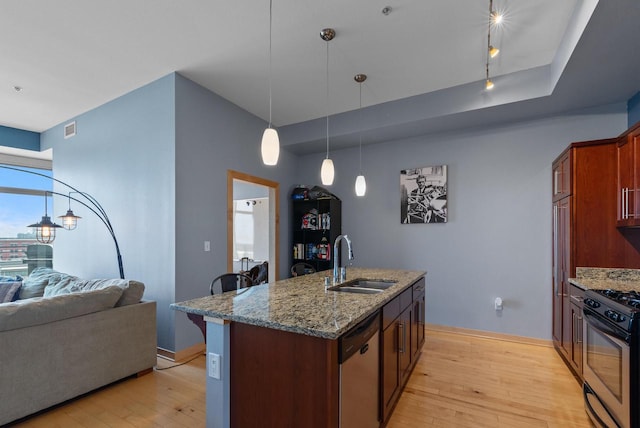 106 W Seeboth St Unit 702, Milwaukee, WI 53204 - kitchen featuring dishwashing machine, stainless steel range with gas cooktop, light wood-type flooring, light stone counters, and an island with sink
