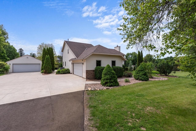 3267 Conestoga Trl, Richfield, WI 53076 - view of home's exterior with a lawn, a chimney, brick siding, a detached garage, and an outbuilding
